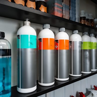 Plastic bottles with car cleaning chemical bottles in car service close up